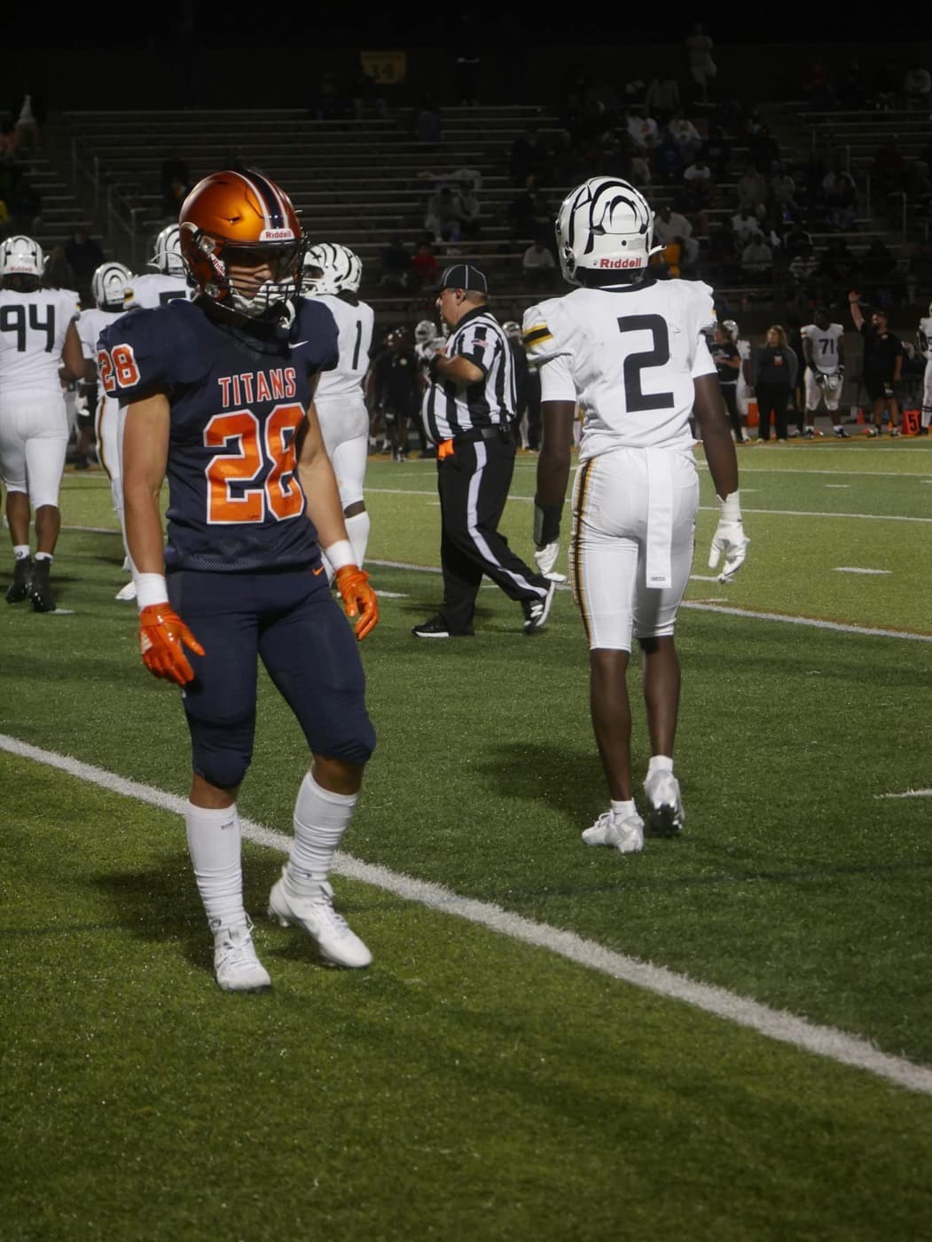American football players under stadium lights