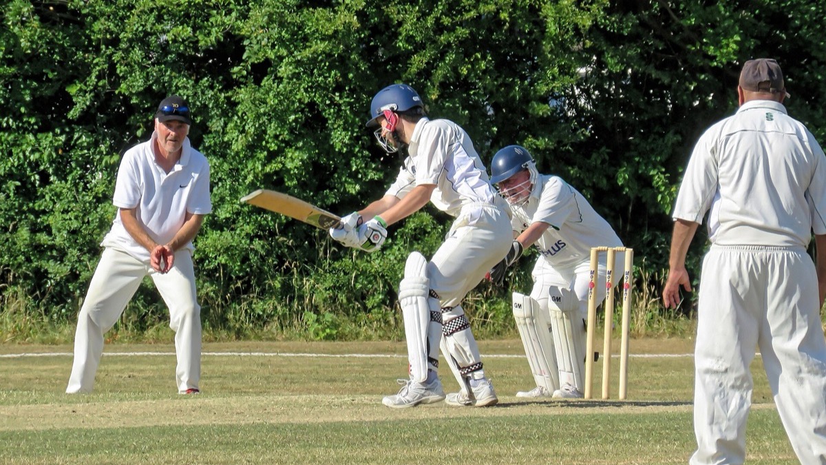 Batsman playing a shot during a community cricket match